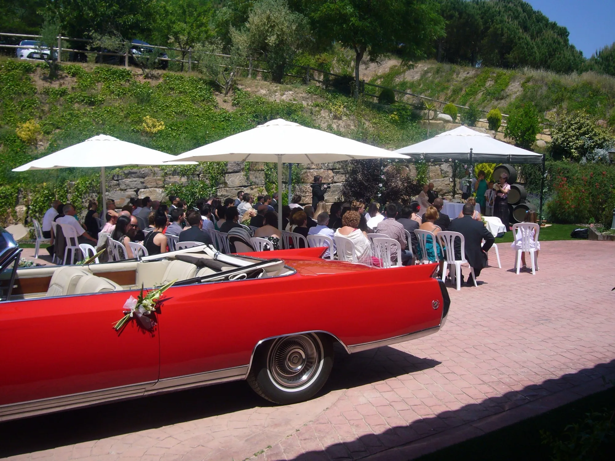 Evento al aire libre en la finca con un coche clásico rojo